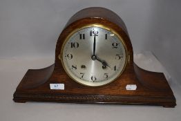 A 1930's oak arched mantel clock, nicely moulded to the base.