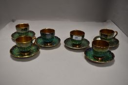 A Carlton ware part coffee set, of lobed circular form with gilt interiors and 'jewelled' exteriors,