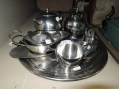 A selection of stainless table ware including tea pots,cruet and more.