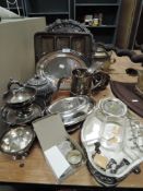 A selection of silver plated table wares including ornate salver and lidded serving trays