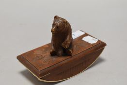 An early 20th century carved wood ink blotter in the form of a German bear