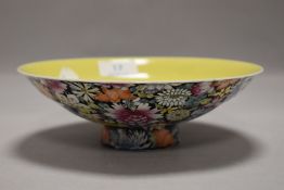 A shallow rice bowl having foot with a yellow inner glaze and a millefiori