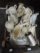 A selection of cream jugs and gravy boats of various designs in white glazes