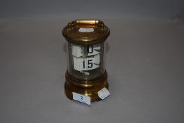 An Edwardian era revolving perpetual date calendar having brass and glass case