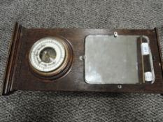 An Edwardian hall way mirror and aneroid barometer