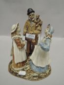 A Rosseau figurine depicting man with monkey and music box and two girls.AF