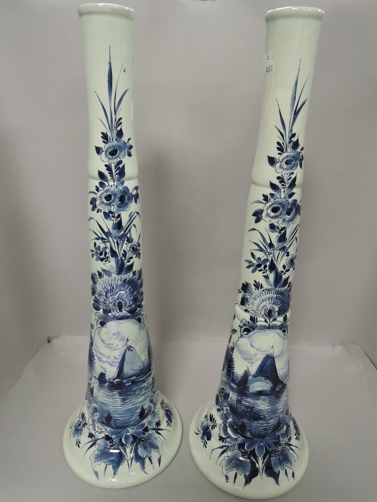 A pair of late 19th century Dutch delft trumpet form vases tin glazed bearing signature to base