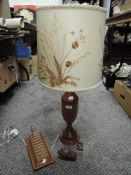 A mid century teak turned wood lamp with collage style shade