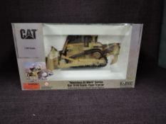 A Norscot 1:50 scale diecast, CAT Machine at Work Series D11R Track Type Tractor in yellow, in