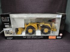 A Norscot 1:50 scale diecast, CAT 994F Wheel Loader in yellow, in polystyrene packaging and in