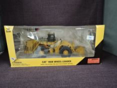 A Norscot 1:50 scale diecast, CAT 993K Wheel Loader in yellow, in plastic packaging and in window