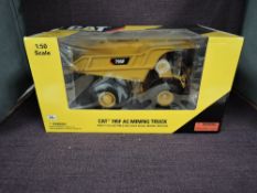 A Norscot 1:50 scale diecast, Cat 795F AC Mining Truck, in original window display box 55515