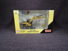 A Norscot 1:50 scale diecast, CAT 323DL Hydraulic Excavator in yellow, in plastic packaging and in