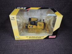 A Norscot 1:50 scale diecast, CAT D7E Track Type Tractor with Electric Drive in yellow, in plastic