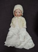 An early 20th century Armand Marseille bisque headed doll having sleep blue eyes, open mouth with