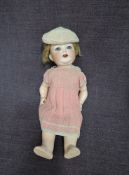 An early 20th century Heubach-Koppelsdorf bisque headed doll having sleep blue eyes, open mouth with