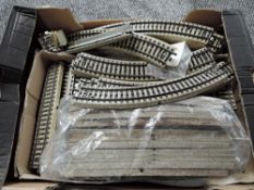 A box containing 125 pieces of Marklin HO Track, approx 25 metres