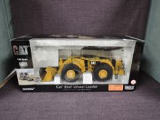 A Norscot 1:50 scale diecast, CAT 994F Wheel Loader in yellow, in polystyrene packaging and in