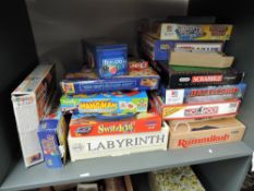 A shelf of modern Board and Card Games including Monopoly, Rummikub, Hangman, Uno etc