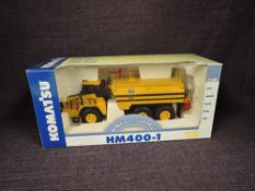 A Joal 1:50 scale diecast, Komatsu HM400-1 Water Tanker in yellow, in polystyrene packaging and in