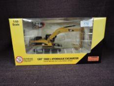 A Norscot 1:50 scale diecast, CAT 336DL Hydraulic Excavator in yellow, in plastic packaging and in