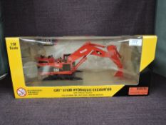 A Norscot 1:50 scale diecast, CAT 5110B Hydraulic Excavator in red Syncrude, in plastic packaging