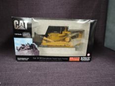 A Norscot 1:50 scale diecast, CAT D11R Carrydozer Track Type Tractor in yellow, in polystyrene