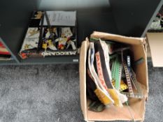 A shelf of mixed vintage Meccano including No 5 part set, instruction booklets and loose parts