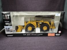 A Norscot 1:50 scale diecast, CAT 994F Wheel Loader in yellow, in polystyrene packaging and in