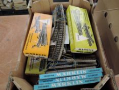 A box containing 31 sets of Marklin HO scale Track, some boxed