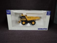 A Universal Hobbies 1:50 scale diecasts, Komatsu HD605 Dump Truck in yellow, in polystyrene