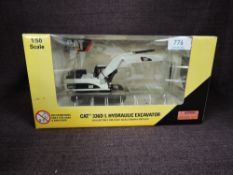 A Norscot 1:50 scale diecast, CAT 336DL Hydraulic Excavator in white, in plastic packaging and in