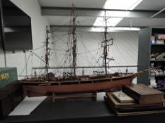 A wooden hand made scale model, Cutty Sark, with rigging on wooden stand