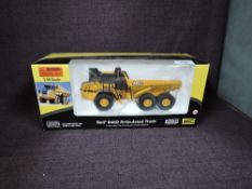 A Norscot 1:50 scale diecast, Bell B40D Articulated Truck in yellow, in polystyrene packaging and in