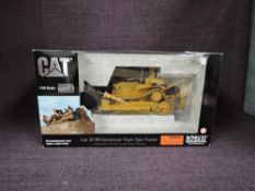 A Norscot 1:50 scale diecast, CAT D11R Carrydozer Track Type Tractor in yellow, in polystyrene