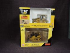 Two Norscot 1:50 scale diecasts, CAT D6T XW VPat Track Type Tractor in yellow, in plastic