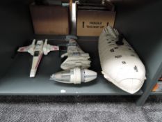 Three unboxed Star Wars vehicles including transport ship, B wing and X Wing