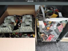 A shelf containing modern Lego including figures, accessories and parts, in a box and a storage bag