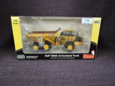 A Norscot 1:50 scale diecast, Bell B50D Articulated Truck in yellow, in plastic packaging and in