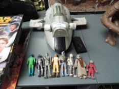 An unboxed Slave 1 Star Wars vehicle with a collection of Bounty Hunters