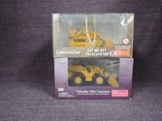 Two Norscot 1:50 scale diecasts, CAT No977 Traxcavator in yellow, in window display box 55170 and