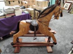 A modern traditional style wooden Rocking Horse with horse hair mane and tail, leather saddle with