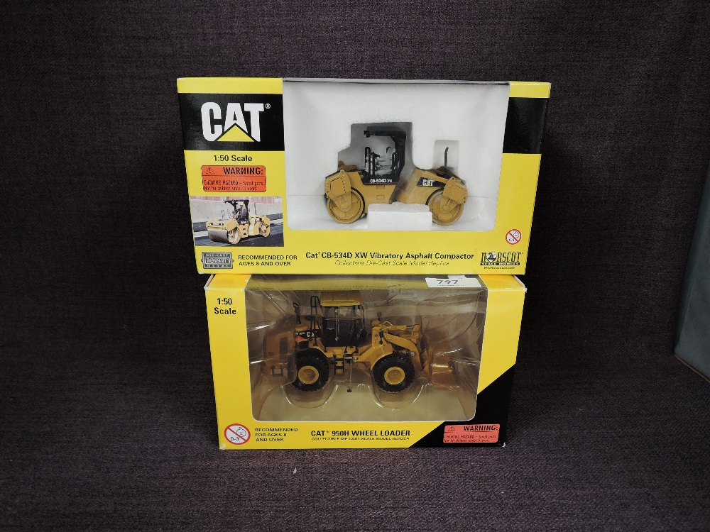Two Norscot 1:50 scale diecasts, CAT 950H Wheel Loader in yellow, in plastic packaging and in window