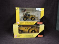 Two Norscot 1:50 scale diecasts, CAT AD45B Underground Articulated Truck in yellow, in plastic
