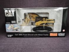 A Norscot 1:50 scale diecast, CAT 365C Front Shovel with Metal Tracks in yellow, in polystyrene