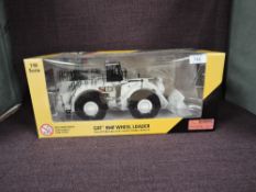 A Norscot 1:50 scale diecast, CAT 994F Wheel Loader in white, in plastic packaging and in window