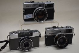 Three Olympus Cameras. An Olympus 35SP, an Olympus 35RC and an Olympus Pen EES2