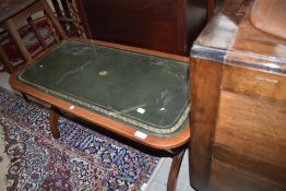 A reproduction Regency coffee table having skiver top