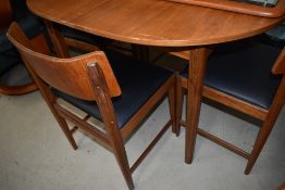 A vintage teak and ply dining table and four chairs