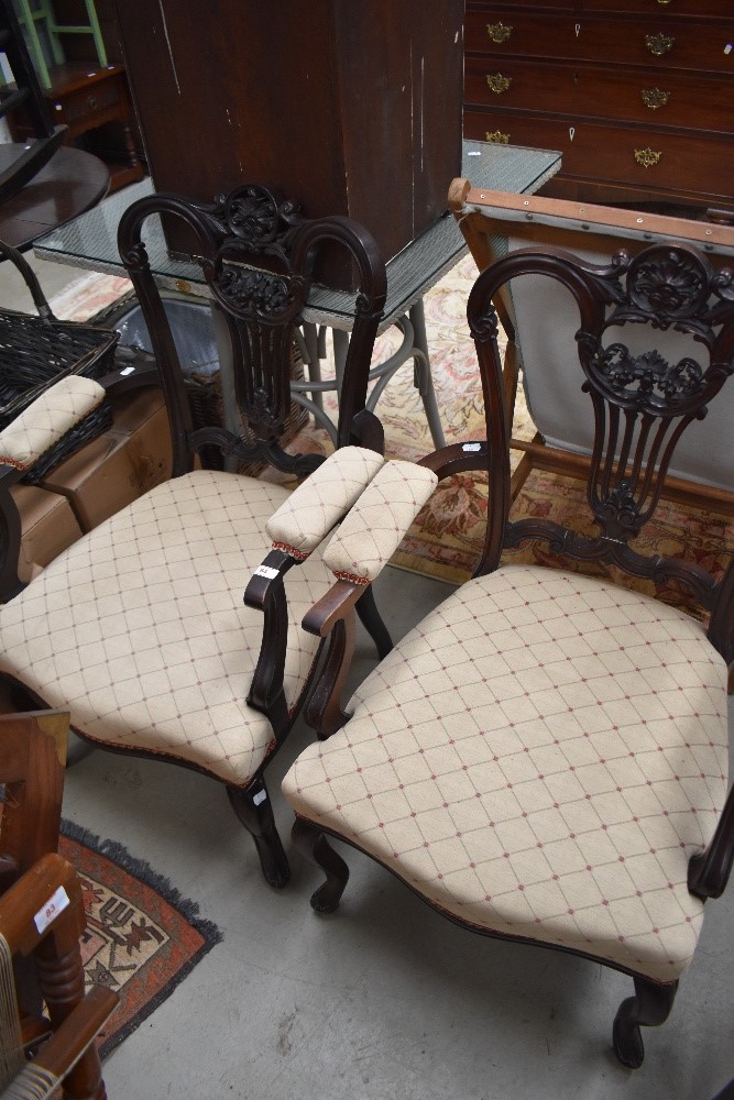 A pair of early 20th Century mahogany framed carver chairs having later upholstery